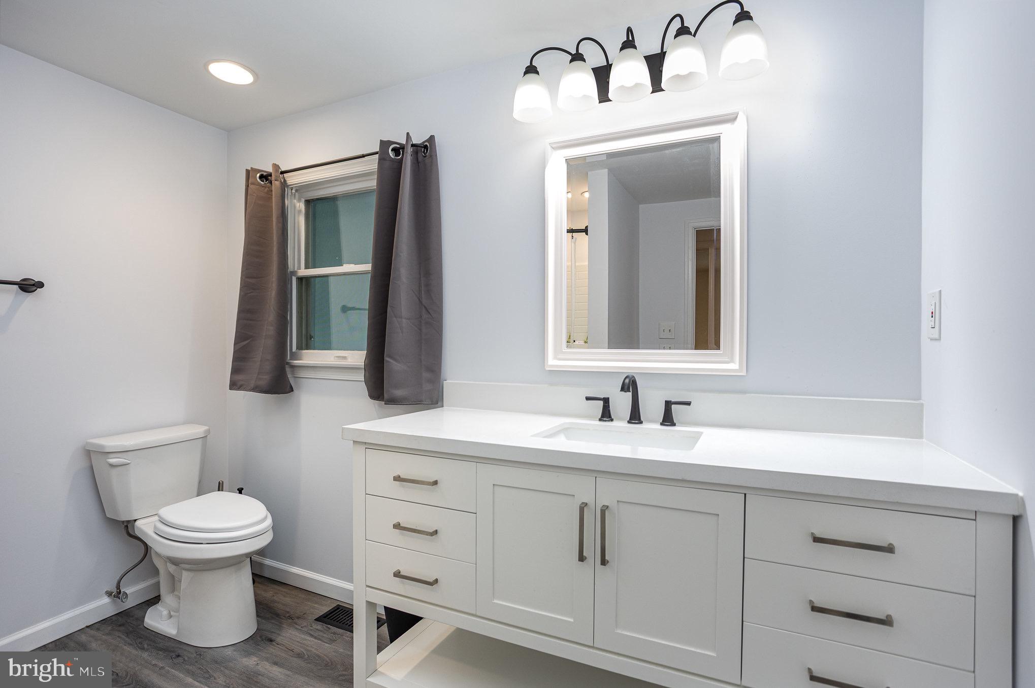 7307 Tred Avon Road Middle River, MD 21220 - Photo 23 of 39 a bathroom with a toilet sink and mirror