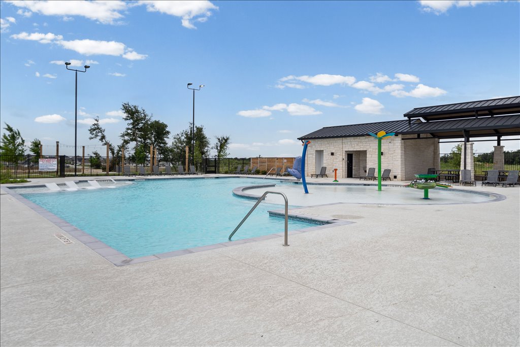 158 Gullivers Drive Elgin, TX 78621 - Photo 31 of 36 You get full access to this gorgeous community center, which features a massive sparkling pool, a shallow splash pad area for the kiddos, a covered pavilion with picnic tables, and a sunbathing deck with plenty of lounge chairs. It feels like a vacation right in your own neighborhood.