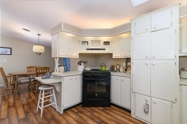 a kitchen with a stove a sink and a refrigerator