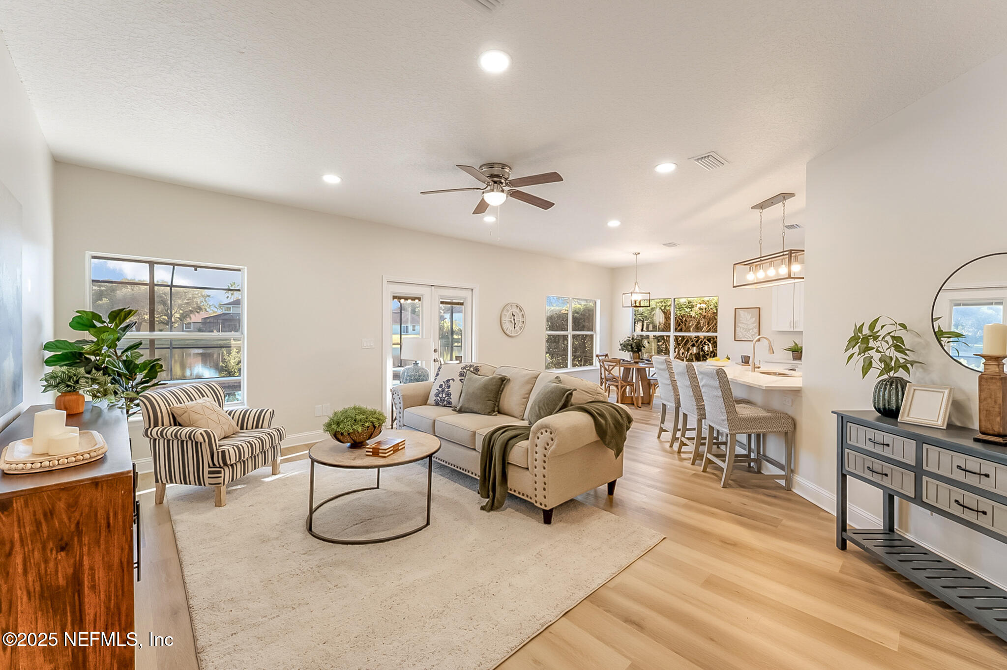 13962 Ibis Point Boulevard Jacksonville, FL 32224 - Photo 13 of 63 a living room with furniture a chandelier and a potted plant