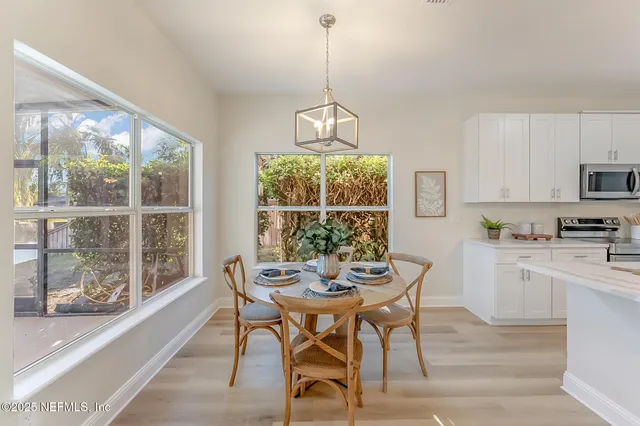 a living room with dining room and wooden floor