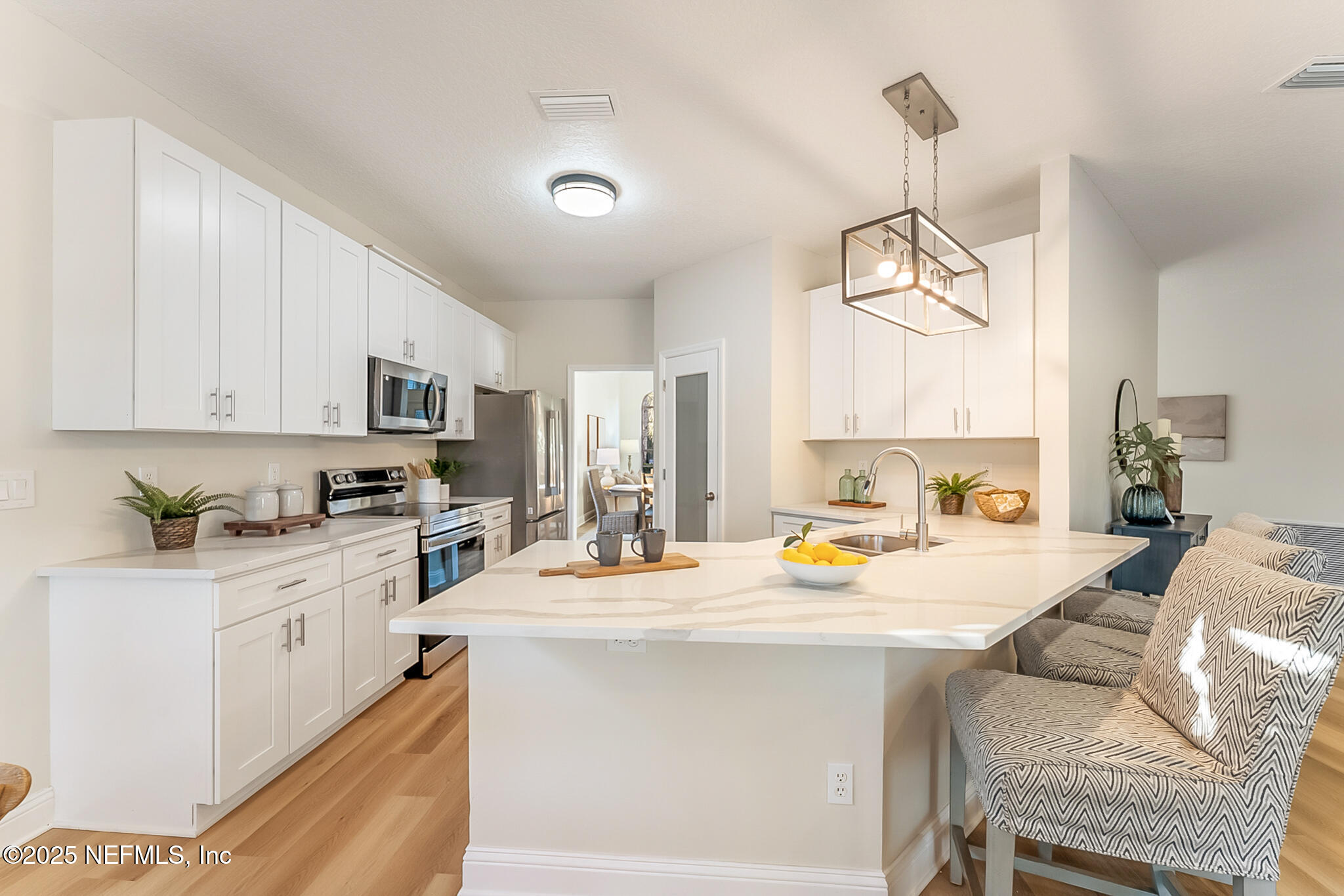 13962 Ibis Point Boulevard Jacksonville, FL 32224 - Photo 17 of 63 a kitchen with stainless steel appliances kitchen island granite countertop a sink and cabinets