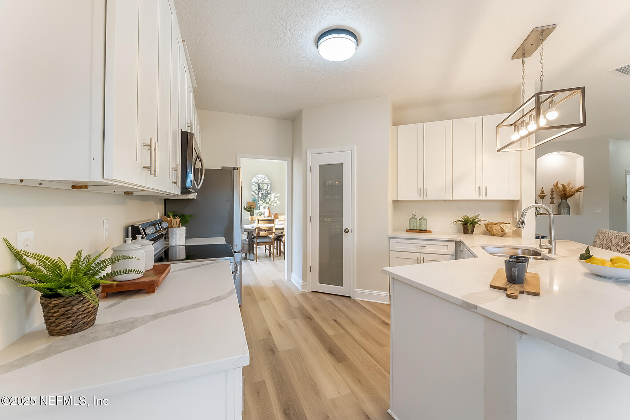 13962 Ibis Point Boulevard Jacksonville, FL 32224 - Photo 18 of 63 a kitchen with a sink a stove and cabinets