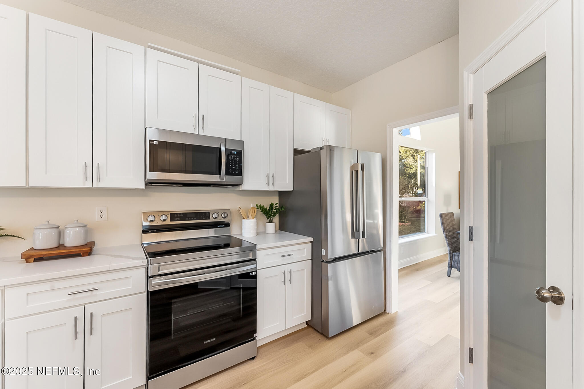 13962 Ibis Point Boulevard Jacksonville, FL 32224 - Photo 20 of 63 a kitchen with a refrigerator stove and microwave
