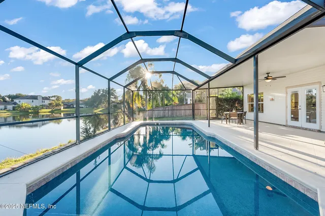 a spacious bathroom with a shower sink and mirror