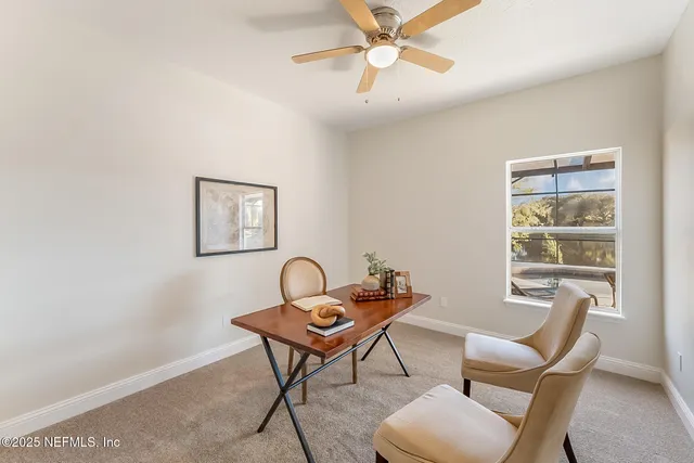 a view of kitchen with granite countertop white cabinets and sink