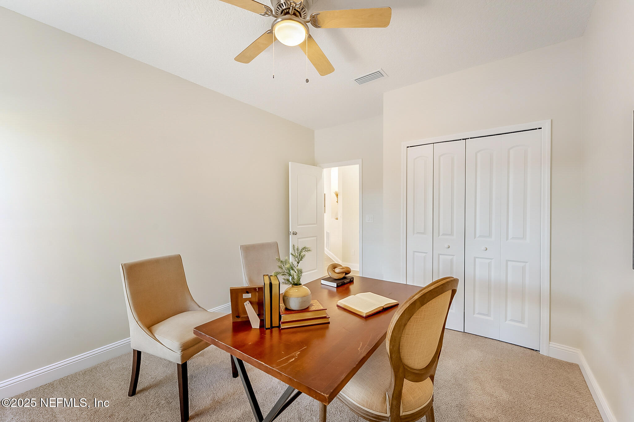 13962 Ibis Point Boulevard Jacksonville, FL 32224 - Photo 23 of 63 a dining room with furniture and a chandelier fan