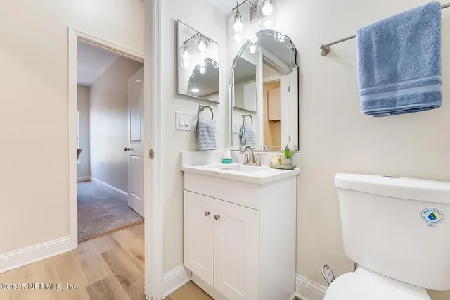 a bathroom with a tub shower and mirror