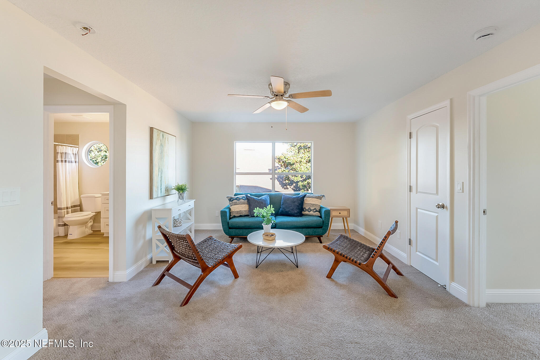 13962 Ibis Point Boulevard Jacksonville, FL 32224 - Photo 27 of 63 a living room with furniture and a chandelier