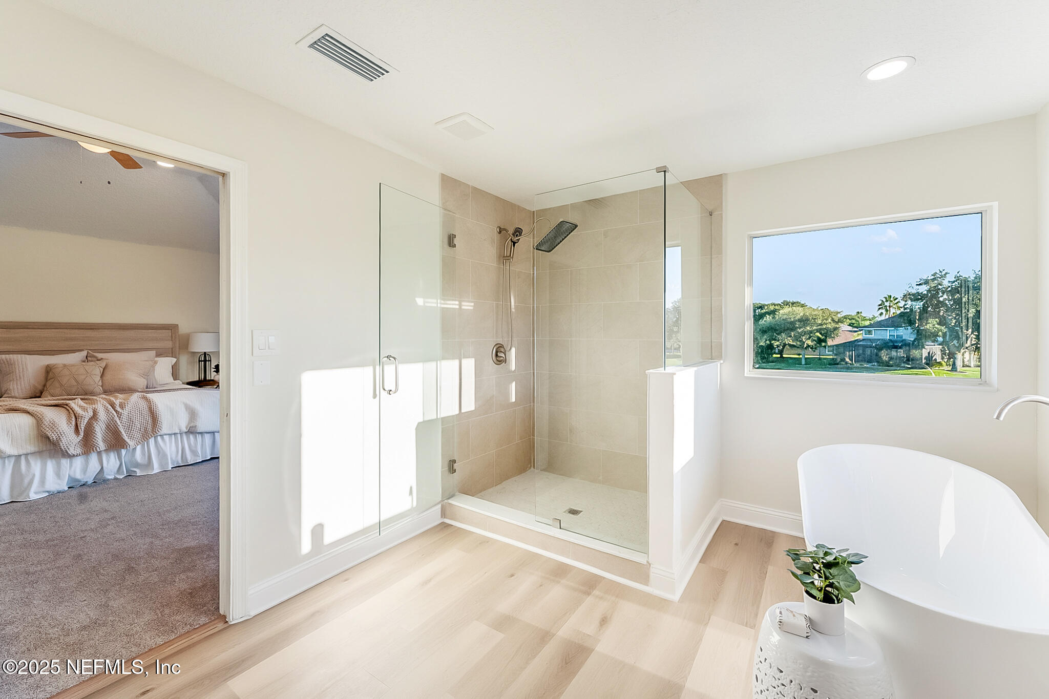 13962 Ibis Point Boulevard Jacksonville, FL 32224 - Photo 32 of 63 a bathroom with a tub shower and mirror