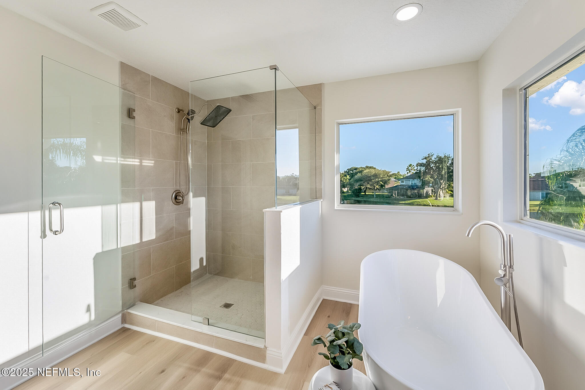 13962 Ibis Point Boulevard Jacksonville, FL 32224 - Photo 33 of 63 a bathroom with a tub shower and mirror