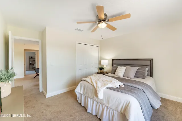 a view of a patio with a table and chairs under an umbrella