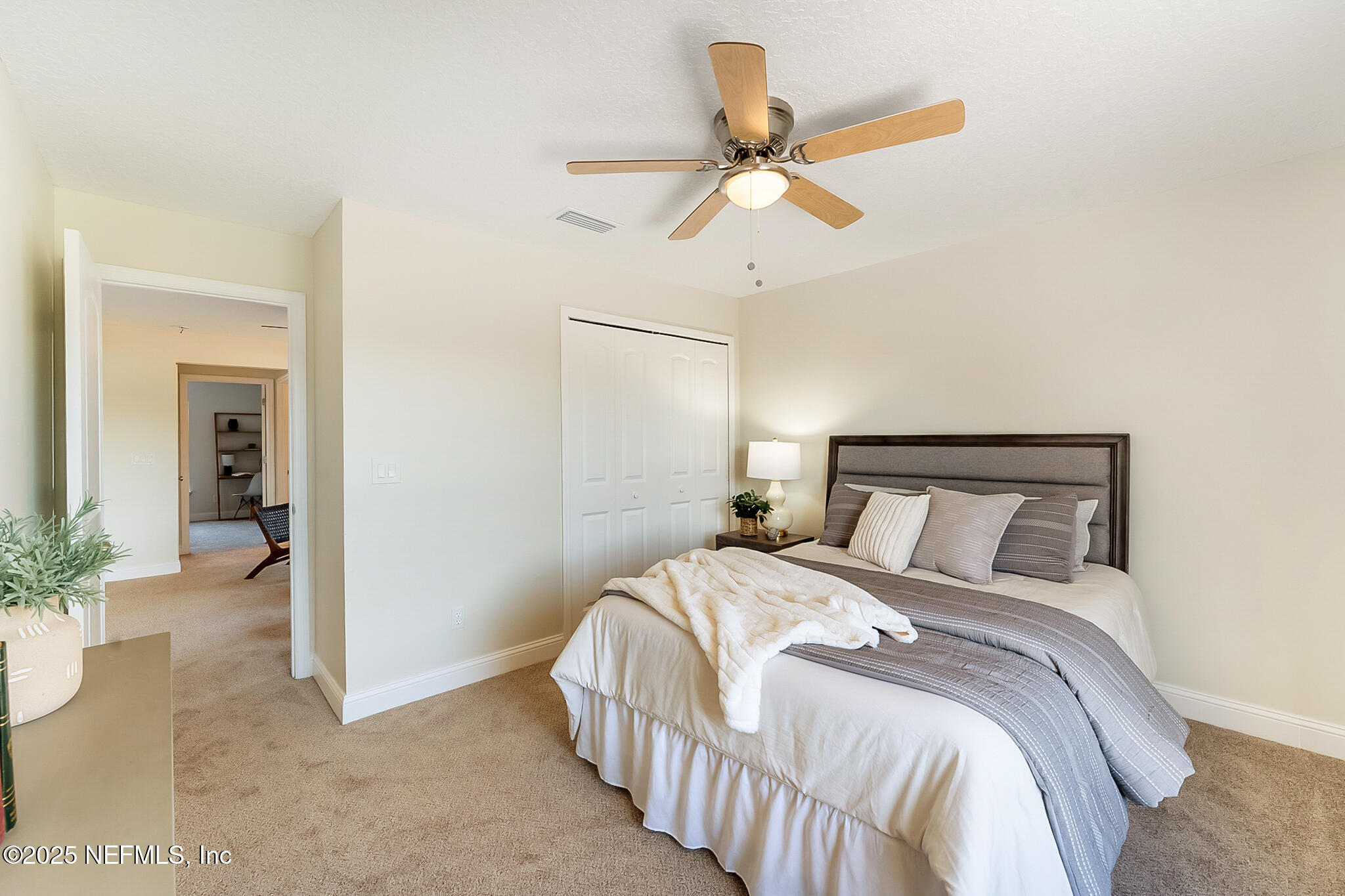 13962 Ibis Point Boulevard Jacksonville, FL 32224 - Photo 36 of 63 a bedroom with a bed and a chandelier