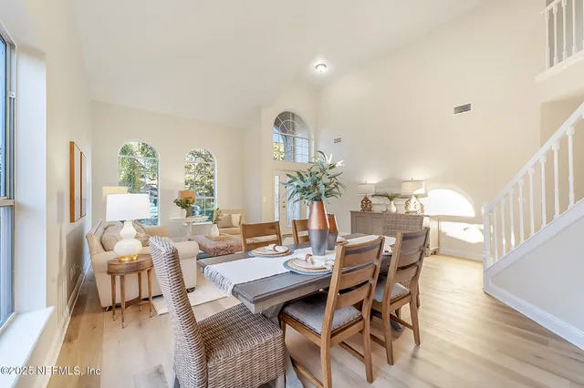 a view of swimming pool with lawn chairs and wooden floor
