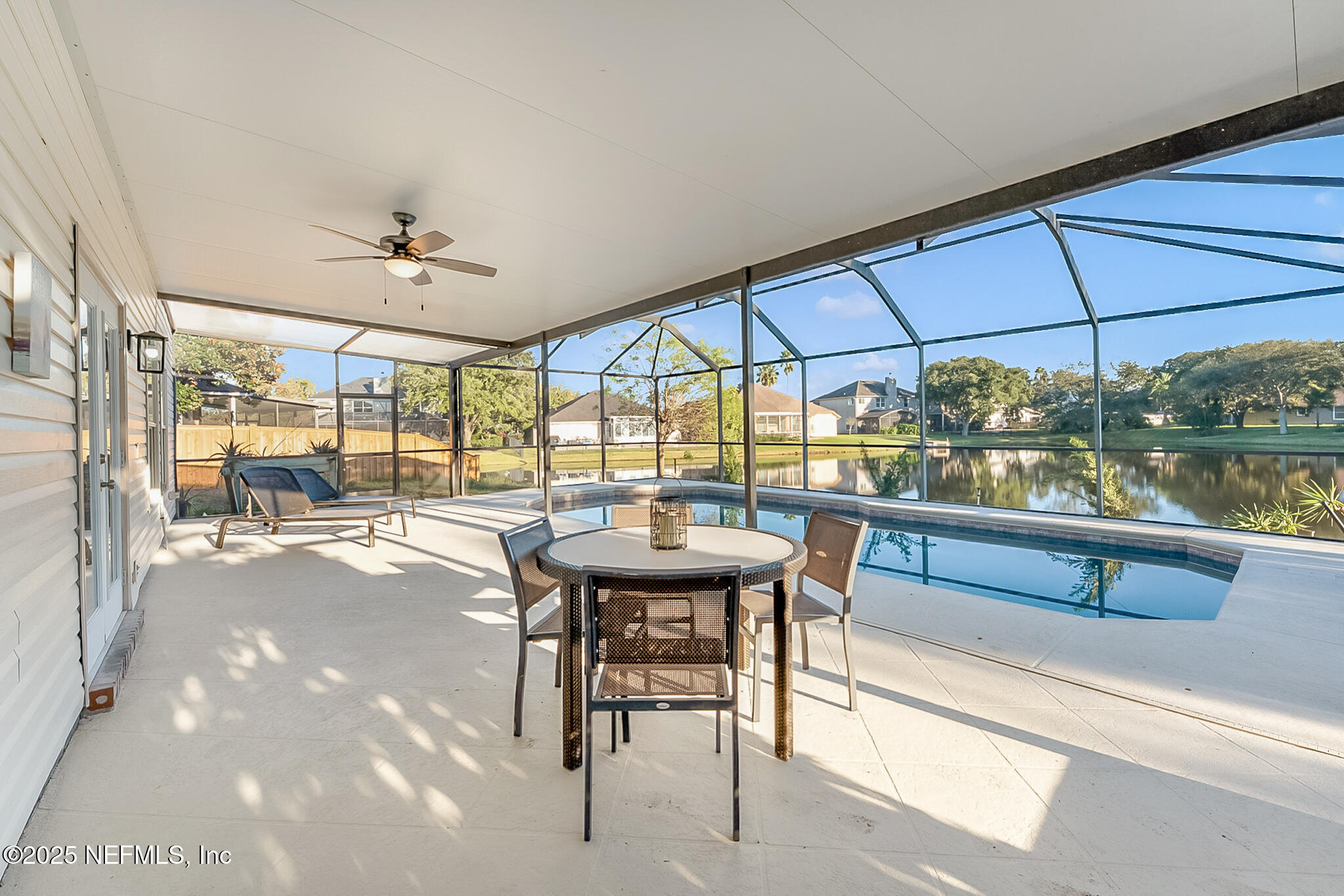 13962 Ibis Point Boulevard Jacksonville, FL 32224 - Photo 44 of 63 a view of a patio with a table and chairs under an umbrella