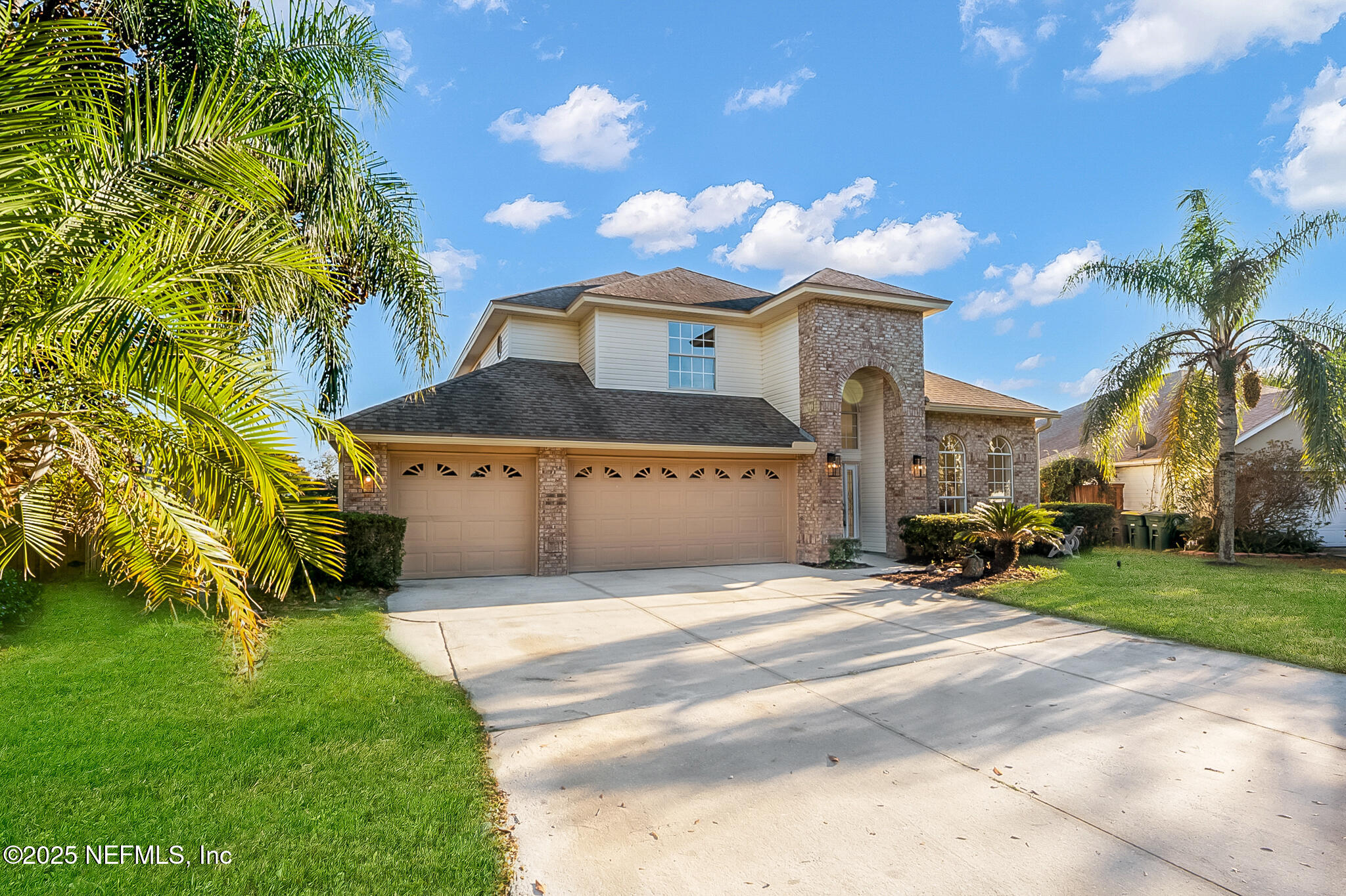 13962 Ibis Point Boulevard Jacksonville, FL 32224 - Photo 5 of 63 a front view of a house with a garden and tree