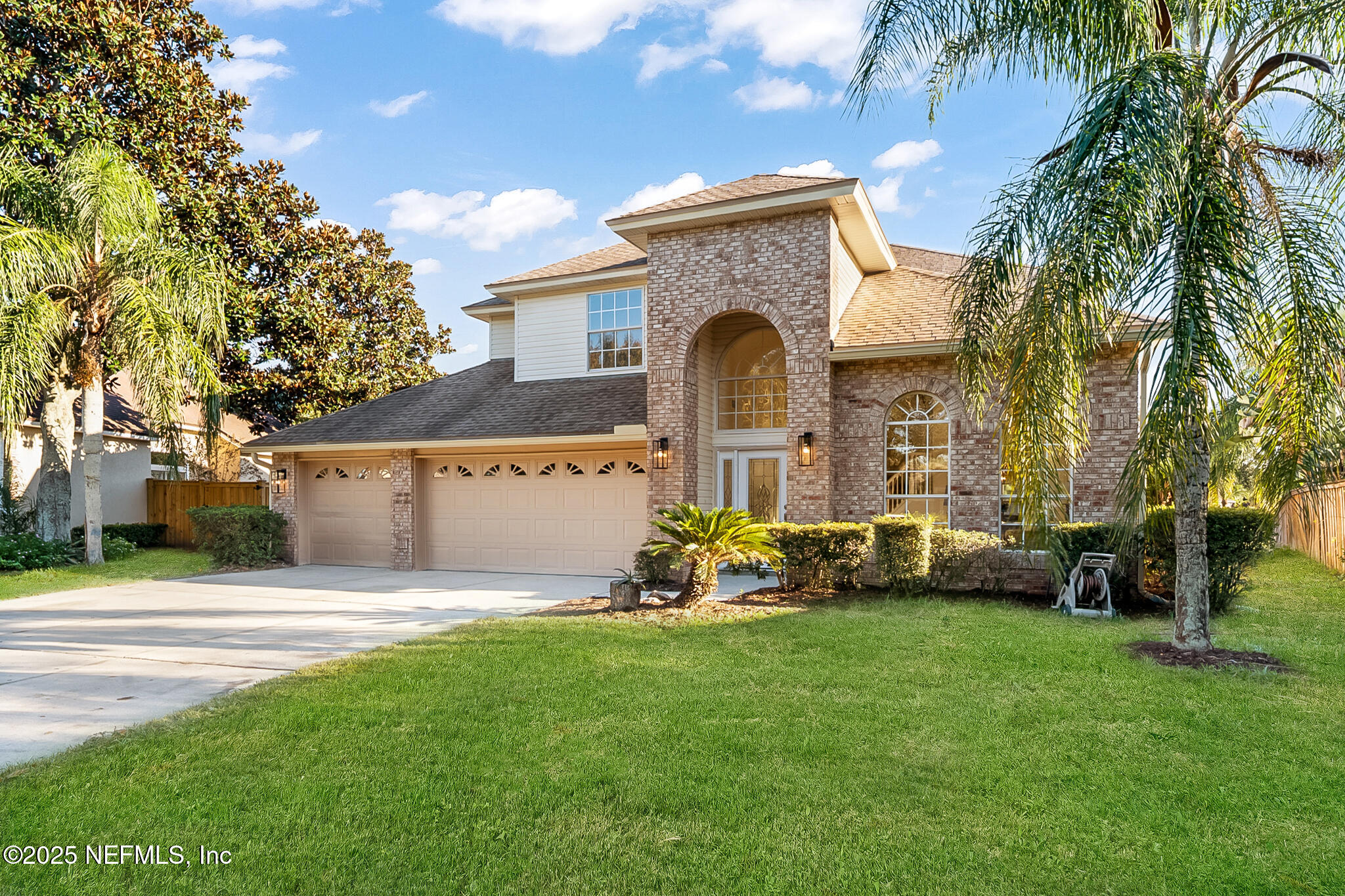 13962 Ibis Point Boulevard Jacksonville, FL 32224 - Photo 6 of 63 a front view of a house with a garden and tree