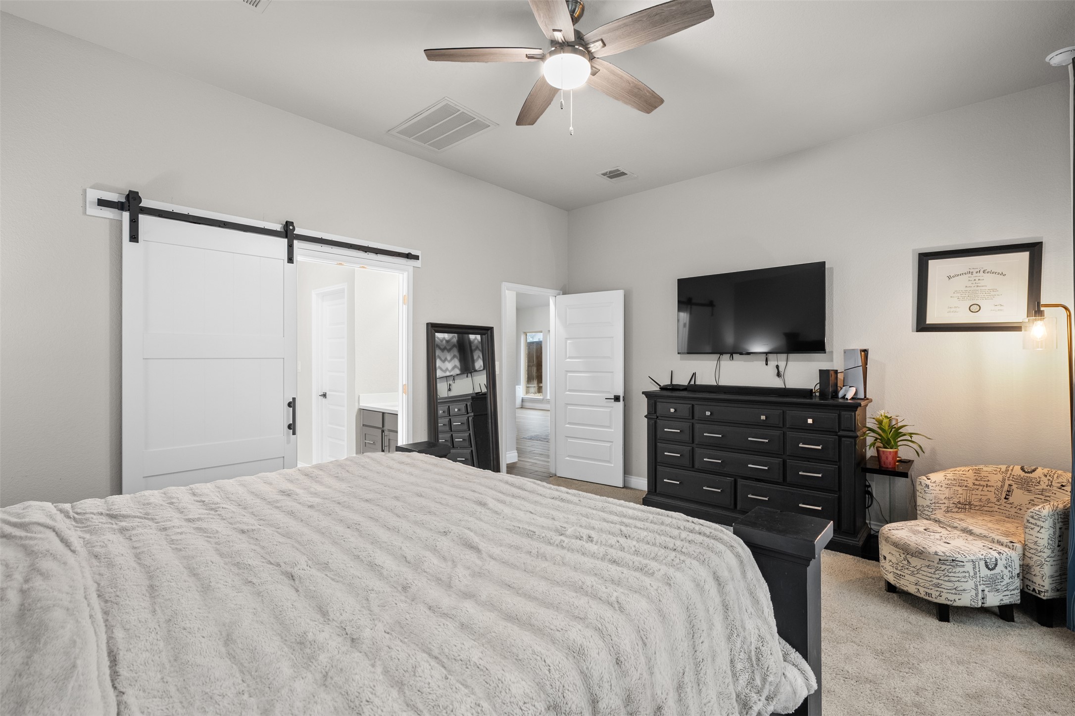 341 Pisa Lane Georgetown, TX 78628 - Photo 20 of 31 a bedroom with a bed and a flat screen tv