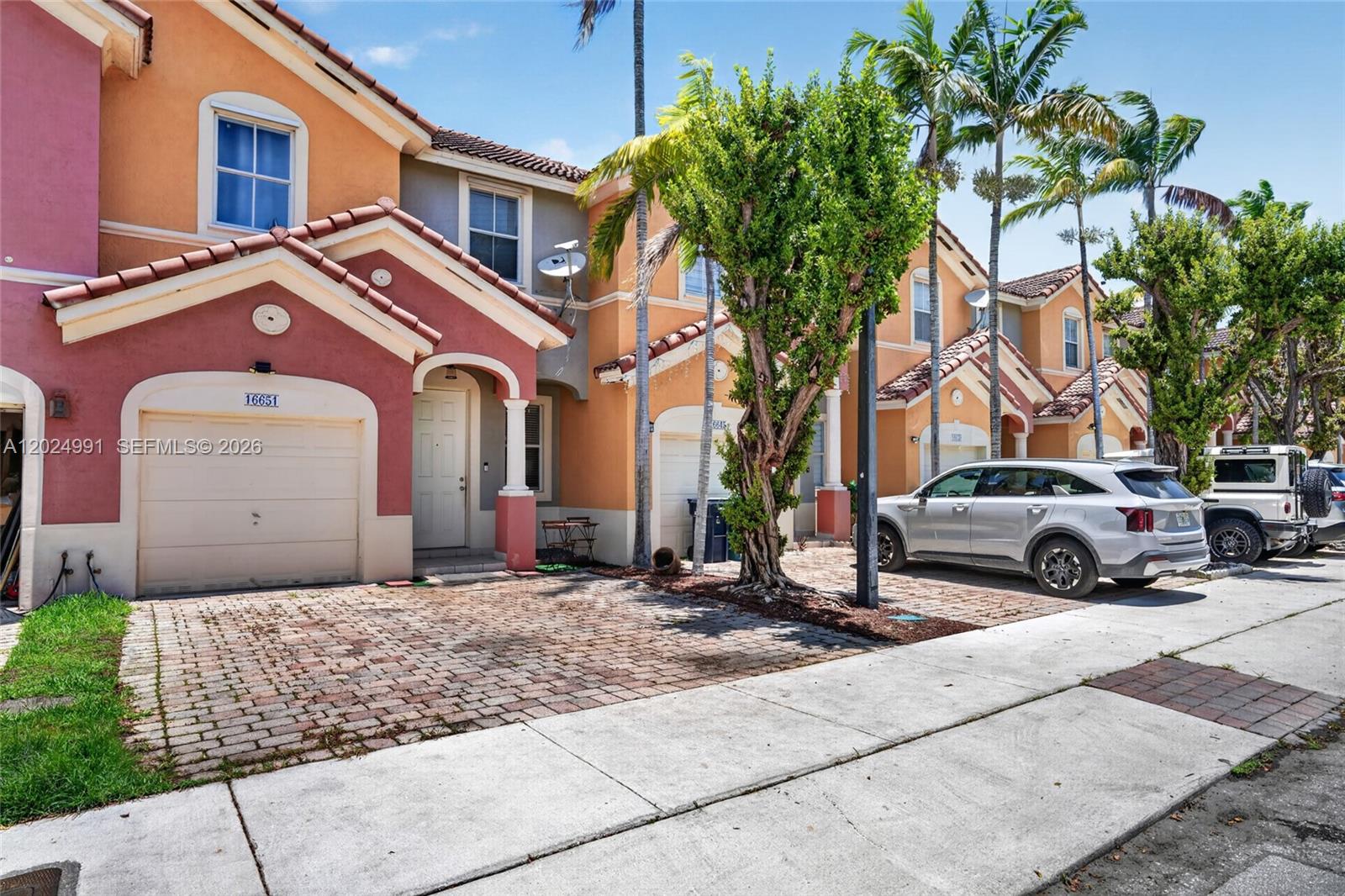 16651 Southwest 79th Terrace Miami, FL 33193 - Photo 2 of 34 a front view of a house with a yard