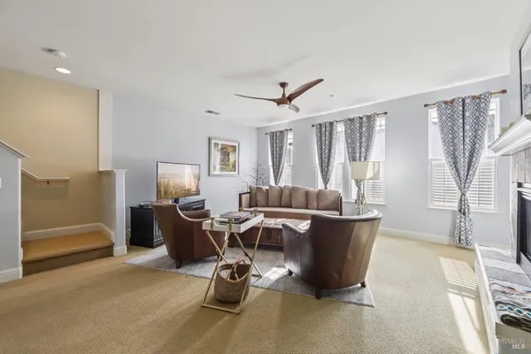 a living room with furniture a window and a table