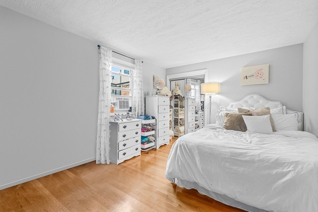 480 Commercial Street, Unit 5B Boston, MA 02109 - Photo 12 of 21 a bedroom with a bed and a window