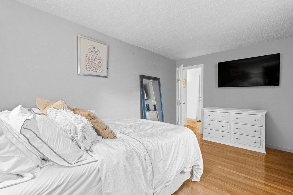 480 Commercial Street, Unit 5B Boston, MA 02109 - Photo 13 of 21 a bedroom with a bed and a flat screen tv