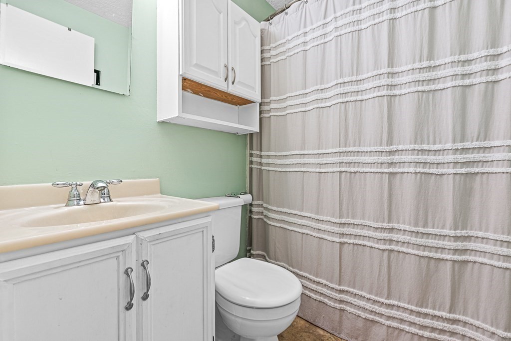 480 Commercial Street, Unit 5B Boston, MA 02109 - Photo 15 of 21 a bathroom with a sink a toilet and a mirror