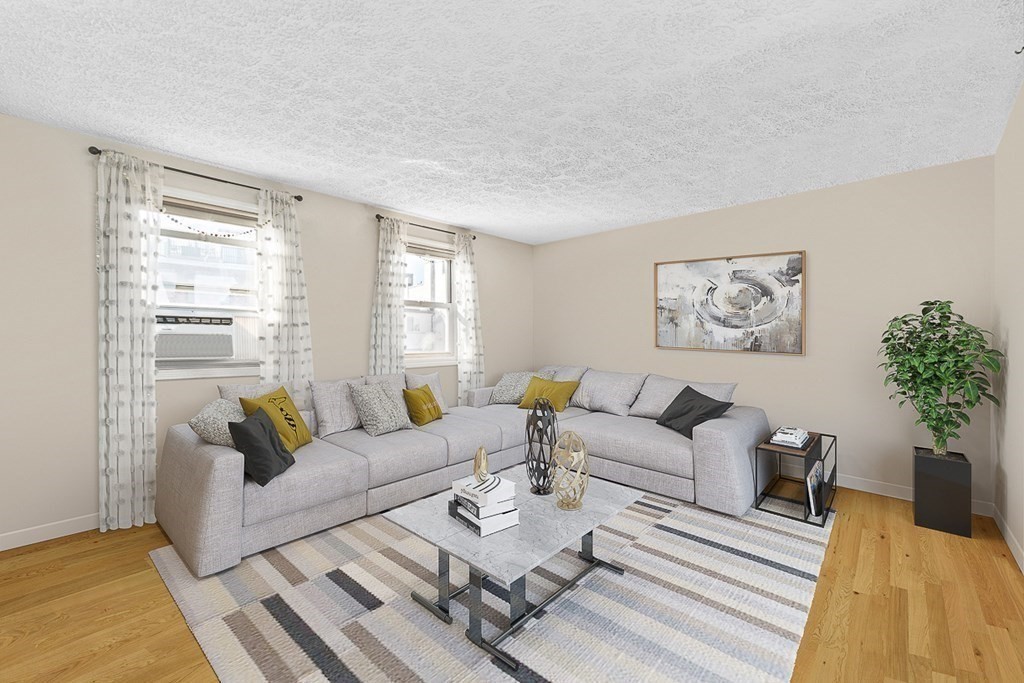 480 Commercial Street, Unit 5B Boston, MA 02109 - Photo 5 of 21 a living room with furniture and a large window