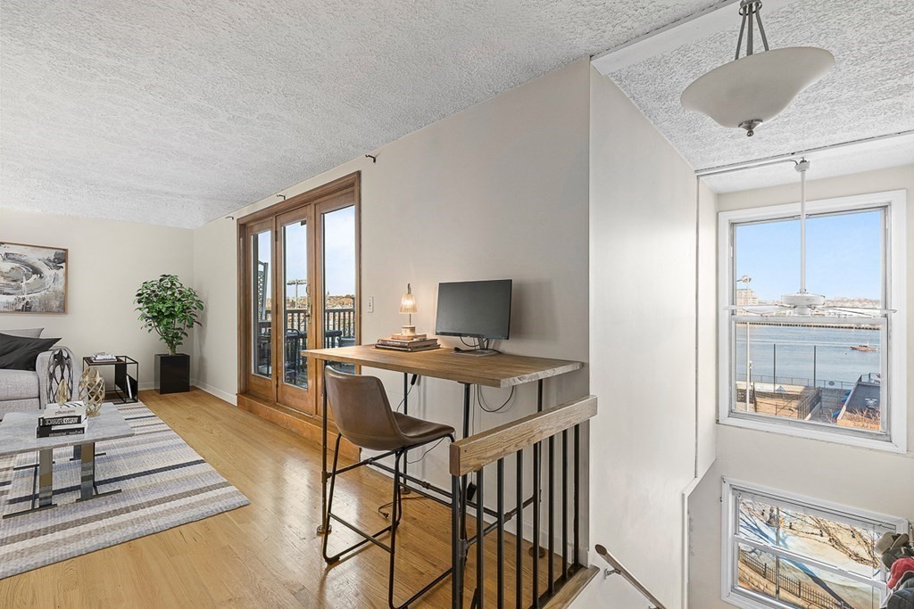 480 Commercial Street, Unit 5B Boston, MA 02109 - Photo 6 of 21 a living room with furniture and a window