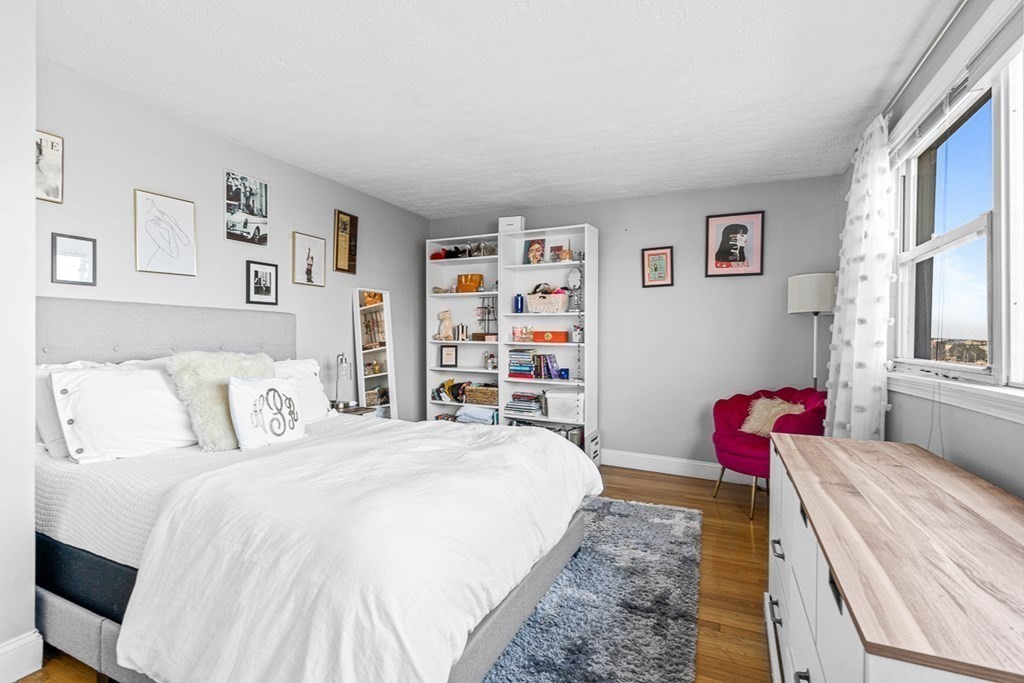 480 Commercial Street, Unit 5B Boston, MA 02109 - Photo 9 of 21 a bedroom with a bed and a couch