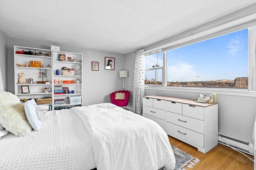 480 Commercial Street, Unit 5B Boston, MA 02109 - Photo 10 of 21 a bedroom with a bed and dresser