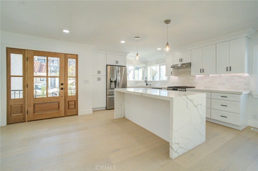 150 Siena Drive Long Beach, CA 90803 - Photo 12 of 40 a large white kitchen with cabinets and a large window