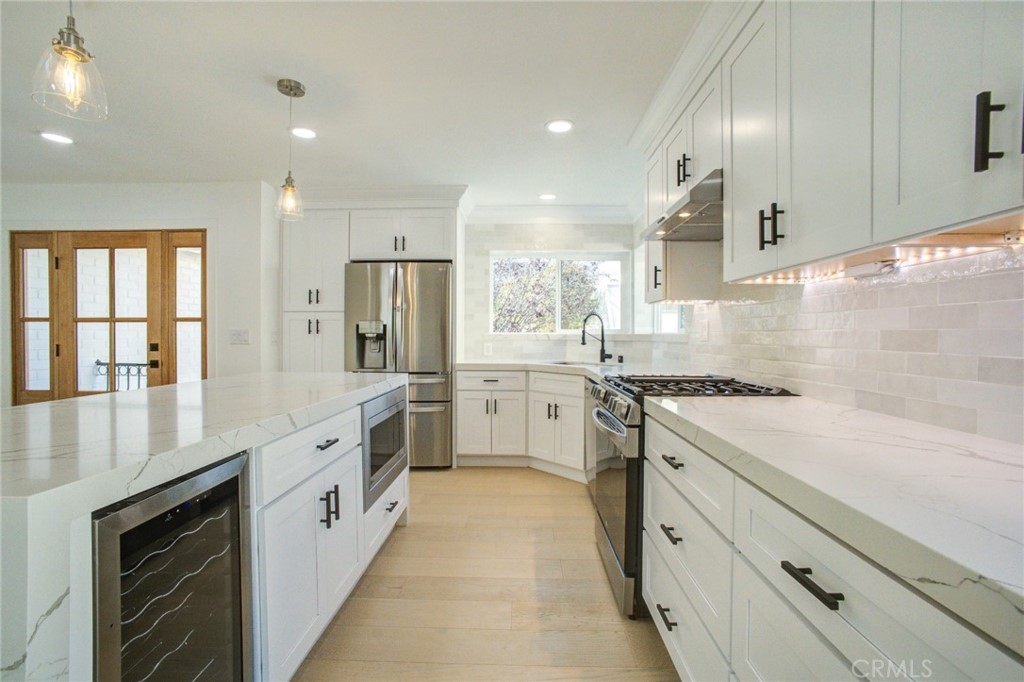 150 Siena Drive Long Beach, CA 90803 - Photo 14 of 40 a large kitchen with stainless steel appliances granite countertop a stove and a sink