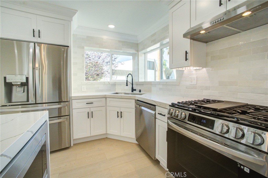150 Siena Drive Long Beach, CA 90803 - Photo 15 of 40 a kitchen with cabinets and stainless steel appliances