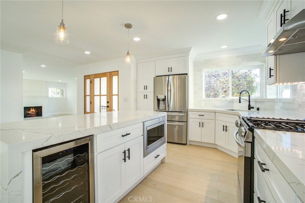 150 Siena Drive Long Beach, CA 90803 - Photo 17 of 40 a kitchen with white cabinets and appliances