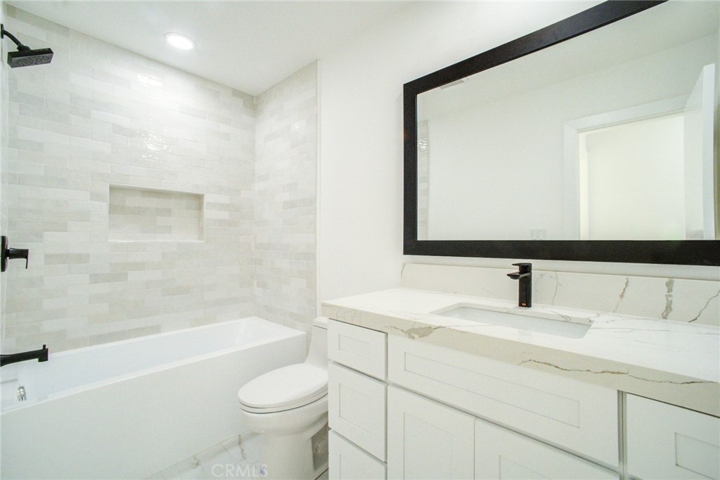 150 Siena Drive Long Beach, CA 90803 - Photo 31 of 40 a bathroom with a granite countertop sink a toilet and a bathtub