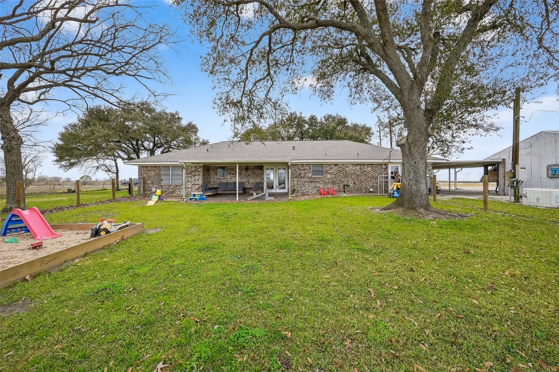 2555 Straznicky Road Beasley, TX 77417 - Photo 22 of 25 Covered patio overlooking wide-open pasture and shade trees.