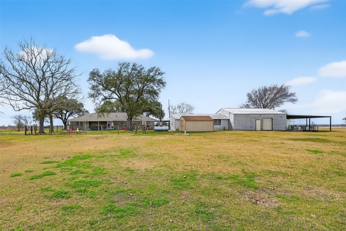 2555 Straznicky Road Beasley, TX 77417 - Photo 3 of 25 Backyard built for sunsets, playtime, and peaceful evenings under the trees.