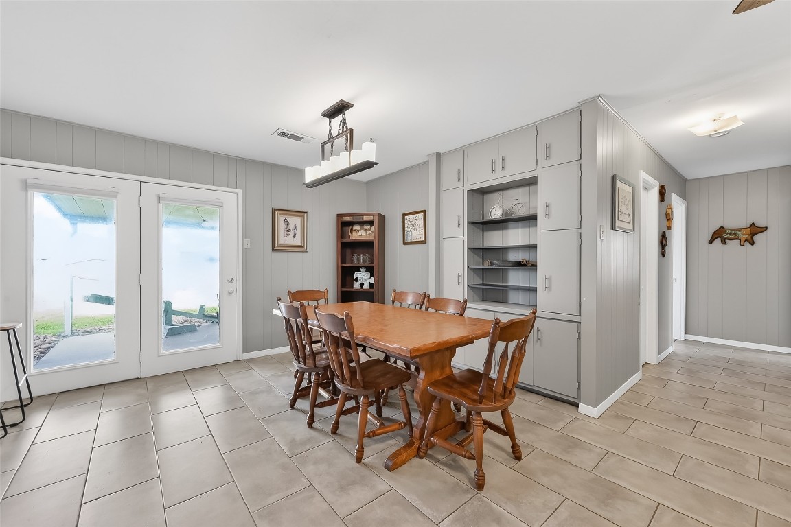 2555 Straznicky Road Beasley, TX 77417 - Photo 9 of 25 Spacious dining area with built-in cabinetry and easy access to covered patio for indoor-outdoor gatherings.