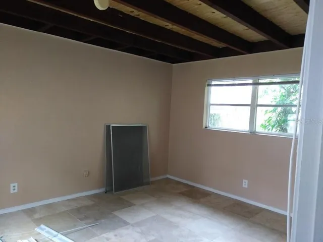 a view of an empty room with a window