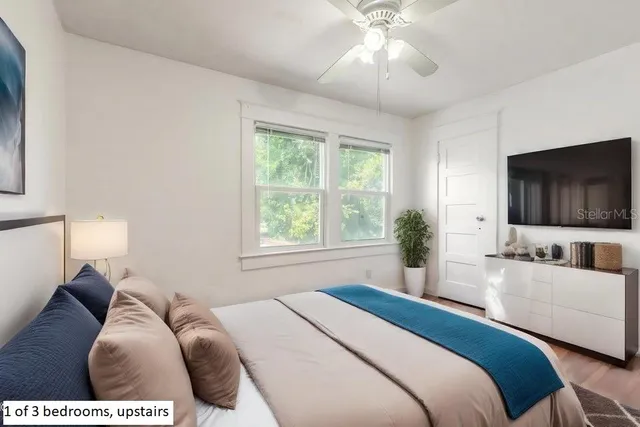 a bedroom with a bed and a flat screen tv