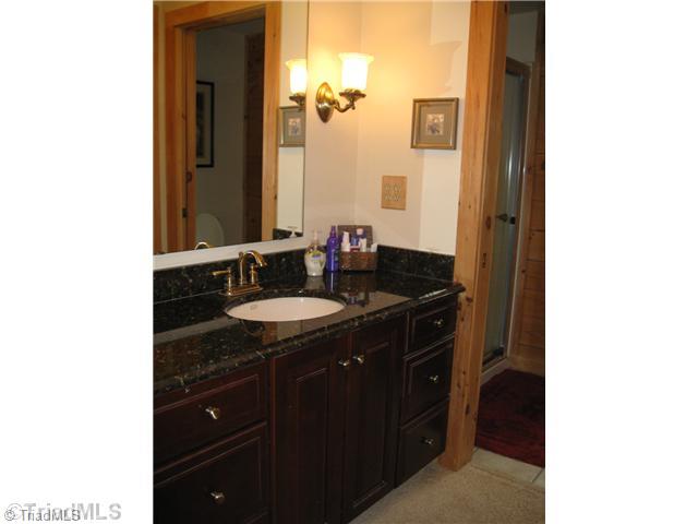 6715 Ventwood Road Climax, NC 27233 - Photo 9 of 16 Master Bath/Spa. The master bath has a granite top vanity, tile flooring, a walk-in shower, and walk-in closet.