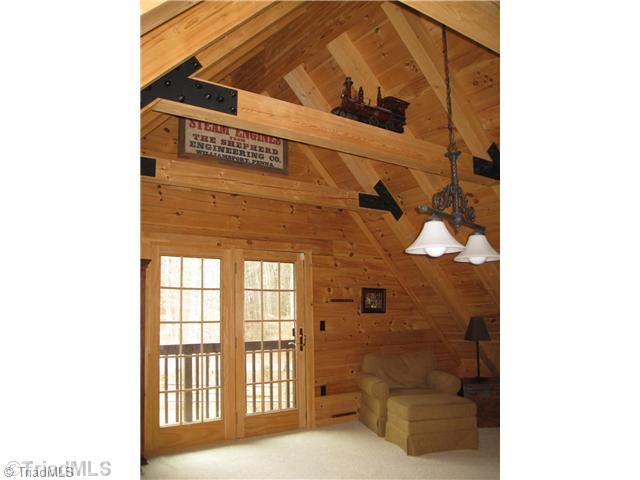6715 Ventwood Road Climax, NC 27233 - Photo 10 of 16 Loft. The large loft has made a great recreation room, that overlooks the den. Attractive A-Frame roof with exposed beams and a deck to step out onto.