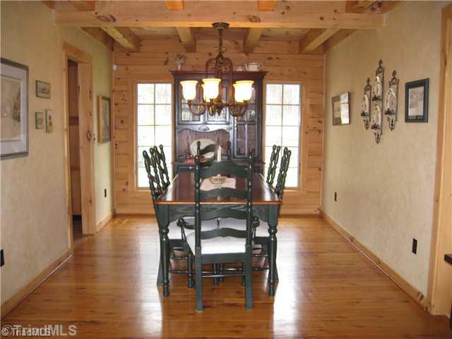 6715 Ventwood Road Climax, NC 27233 - Photo 6 of 16 Dining Room. The dining room is directly off the kitchen and open to the den. Flooring in the home is Australian Cypress Wood. The ceiling lines are high quality and detailed, boasting tongue & groove and exposed beams in many of the rooms.