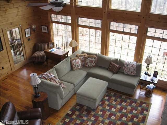 6715 Ventwood Road Climax, NC 27233 - Photo 7 of 16 Den/Family/Great Room. Dramatic two story den is impressive...from the floor to ceiling windows, to the massive stone fireplace, every detail has been well thought out in building this home. Handsome loft/recreation room is overhead, offering great views of the den.