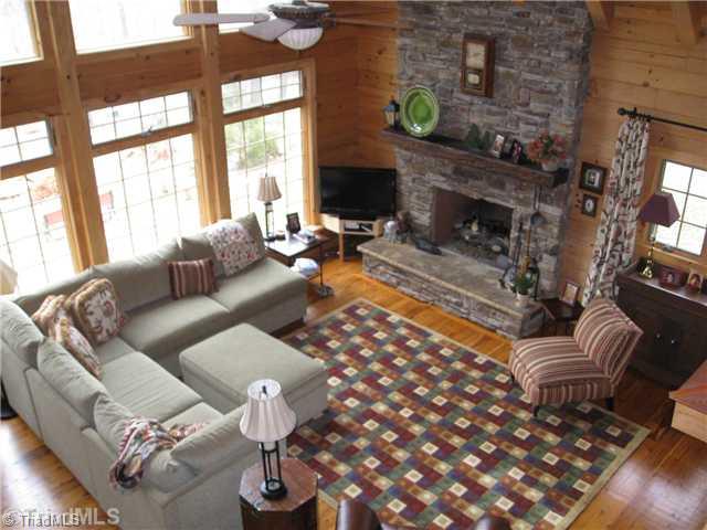 6715 Ventwood Road Climax, NC 27233 - Photo 8 of 16 Den/Family/Great Room. The stone fireplace has gas logs, vaulted ceiling has fan with overhead light, there is a door to the covered side porch.