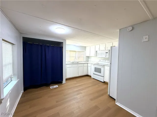 a view of a kitchen with a sink and a stove top oven