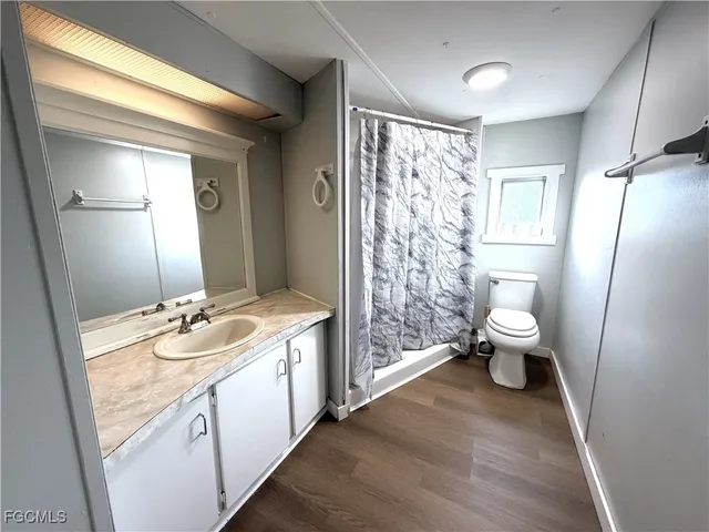 a spacious bathroom with a double vanity sink toilet and a shower