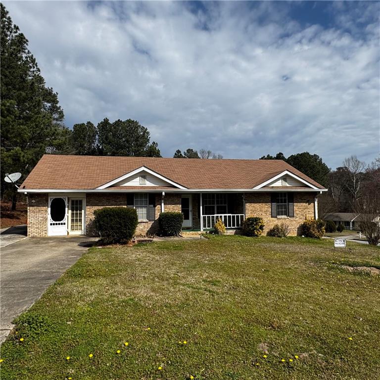 1608 Enchanted Forest Drive Conley, GA 30288 - Photo 2 of 22 a view of a big house with a big yard and large trees