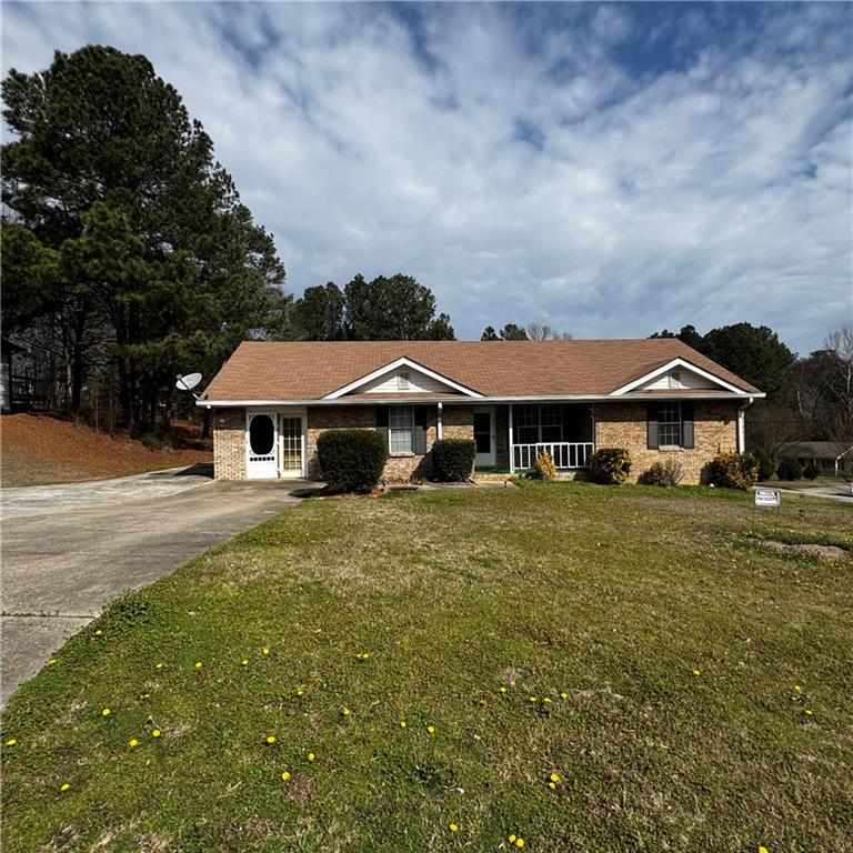1608 Enchanted Forest Drive Conley, GA 30288 - Photo 3 of 22 a front view of a house with garden